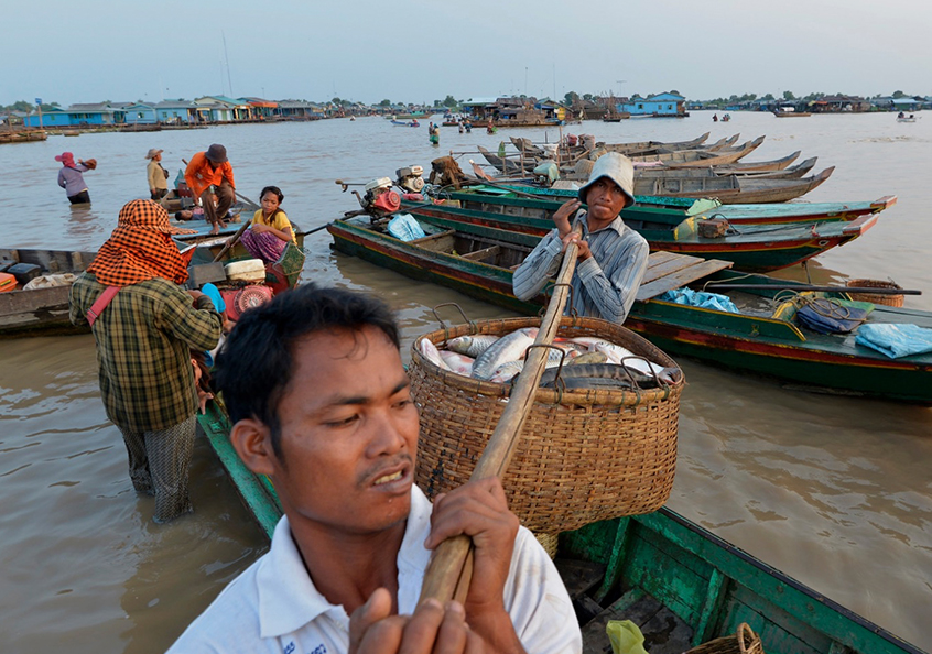 Local workers unloading fresh catch at Chhnoc Trou pier, Kampong Chhnang province, Cambodia