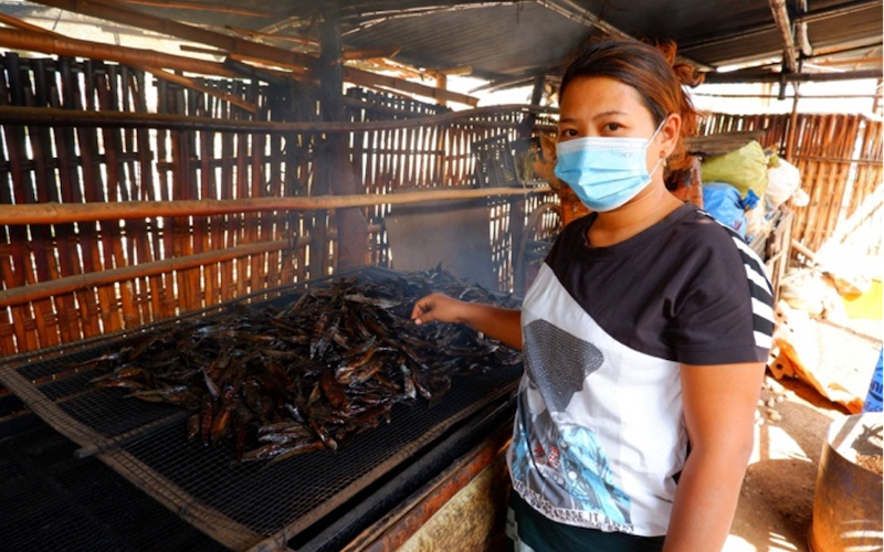 Win Chewa Htun produces smoked fish for a living together with her husband. Photo by Kyaw Moe Oo.