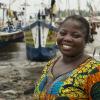 Portrait of Mrs Emelia Abaka-Edu in front of her boat in Axim village, Ghana. Photo by Anna Fawcus, WorldFish.