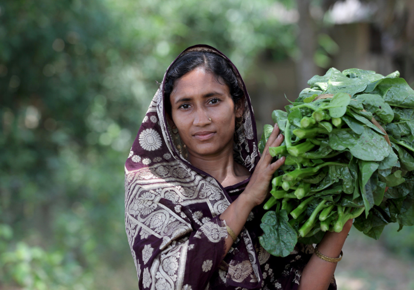 Woman carrying home vegetables in Khulna, Bangladesh