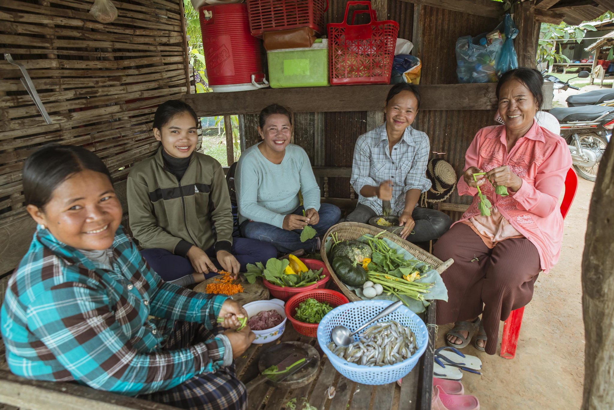 Villagers gather vegetables and fish to prepare a nutritious and healthy meal for the community children in Battambang, Cambodia. Photo by Fani Llauradó.