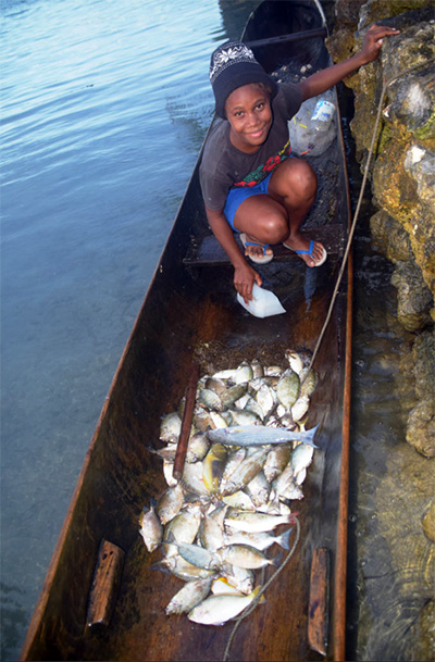 Youth with fish, Solomon Islands. Jan van der Ploeg
