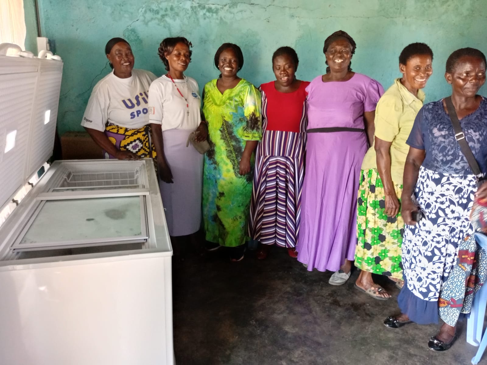 Mewa women self-help group from Nyatike South Sub-county, Muhuru ward, Kikongo market, Migori county, appreciating the use of solar freezer to preserve their fish. The freezer is donated by WorldFish with the support of the CGIAR gender platform (photo taken on: 8th of February, 2024). Photo by Professor Dorothy Amwata. 