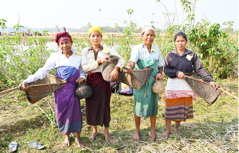 Rabha women with their traditional fishing gear ready to participate in Bahow, their community fishing practice. Photo: SK Dubey