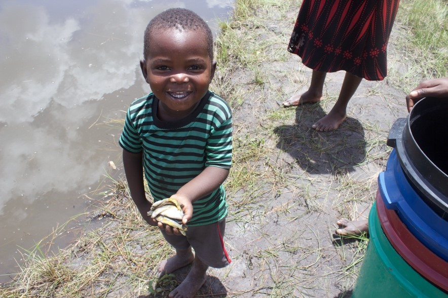 Luwingu boy displaying the results of harvest. 