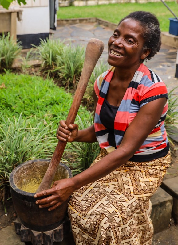 Acinta making fish powder from small dried fish grown in her pond. Photo by Doina Huso