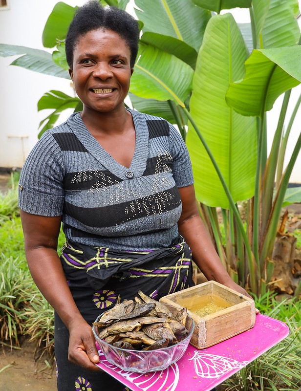 Agnes with dried fish from her pond. Photo by Doina Huso.