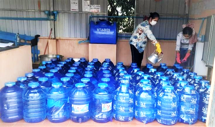 Packaging and distributing water, in one of the water kiosks in Pursat, Cambodia