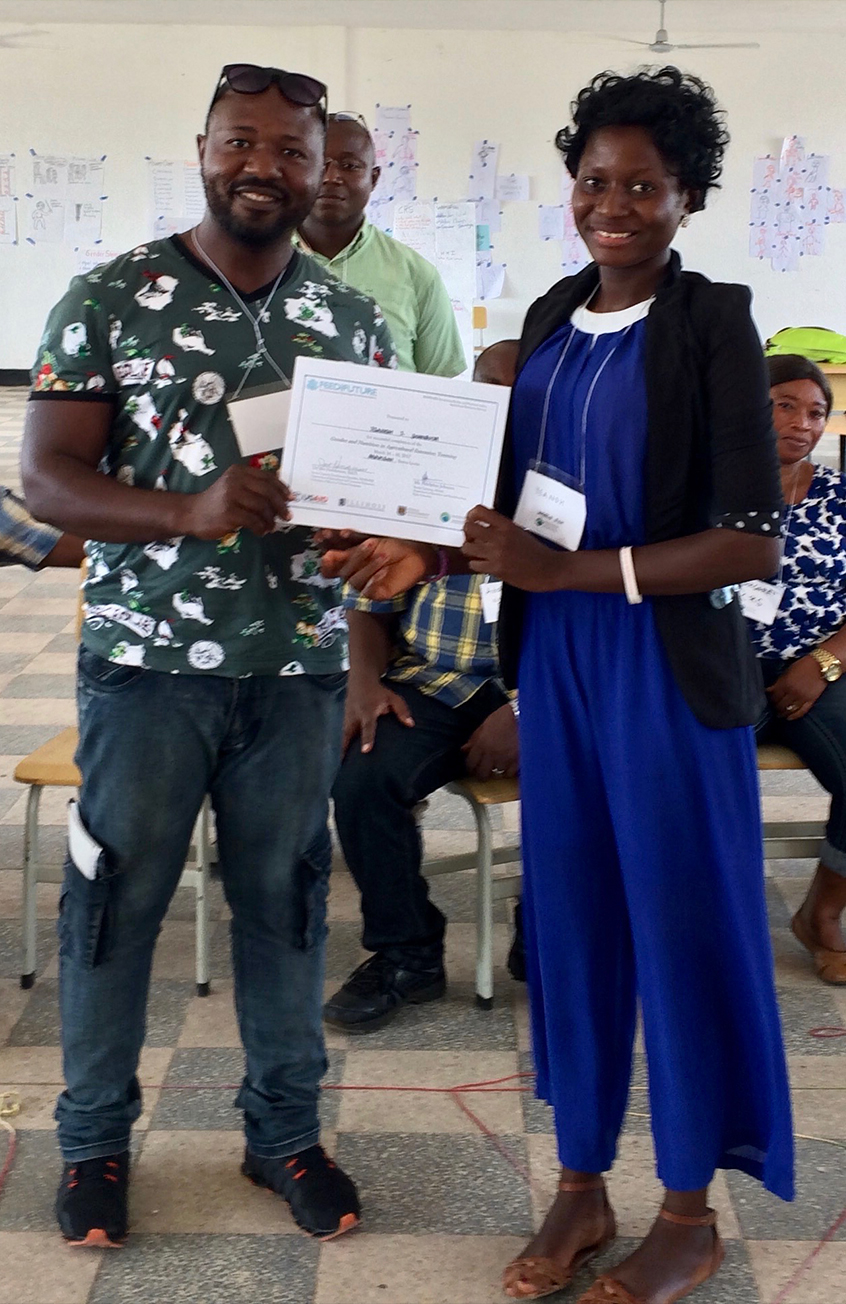 Yeanoh receives a certificate for completing a 3-day Integrating Gender and Nutrition within Agricultural Extension Services Workshop.