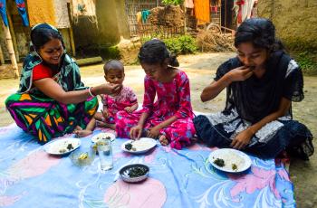 Pronoti Rani and her children eat nutrient-rich small fish in their meal in Moulavibazar, Bangladesh. Photo by Mohammad Mahabubur Rahman. 