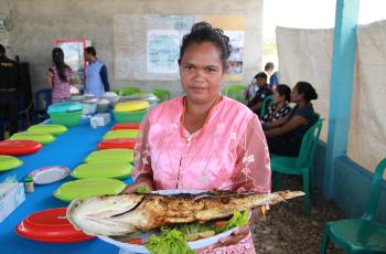 Timorese woman with a traditional fish