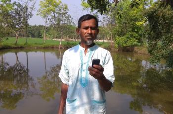 A fish farmer from Rangpur receiving weather forecast from Bangladesh Meteorological Department’s toll-free hot line number. Photo by Harun Or Rashid