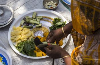 Preparing vegetables for a fish curry in Rangpur, Bangladesh. Photo by Holly Holmes.