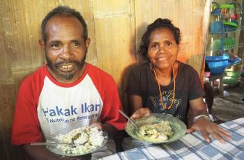 Farmers eating fish in Timor-Leste. Photo by Kate Bevitt.