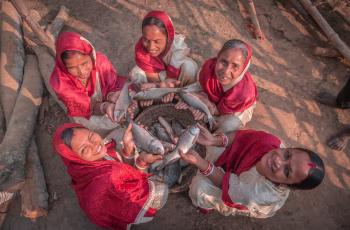 Happy women from Jay Hanuman women self-help group cherishing with their freshly caught fish. Photo by WorldFish.
