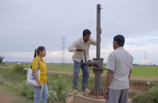 Chea Kong (left) coordinates with local authorities to open the watergate in Santuk District, Kampong Thom, managing water flows that sustain both rice fields and community fish refuges. Photo: WorldFish.
