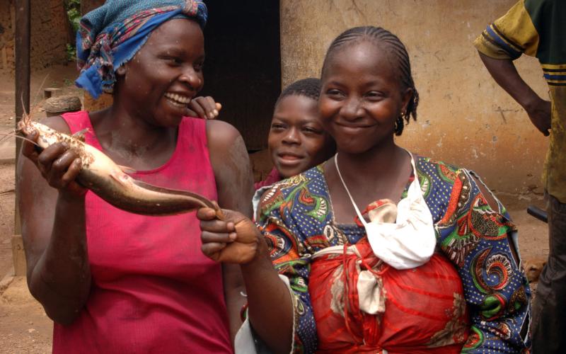 Fisherwomen hold a catfish harvested from their pond in Cameroon. Photo by Randall Brummett.