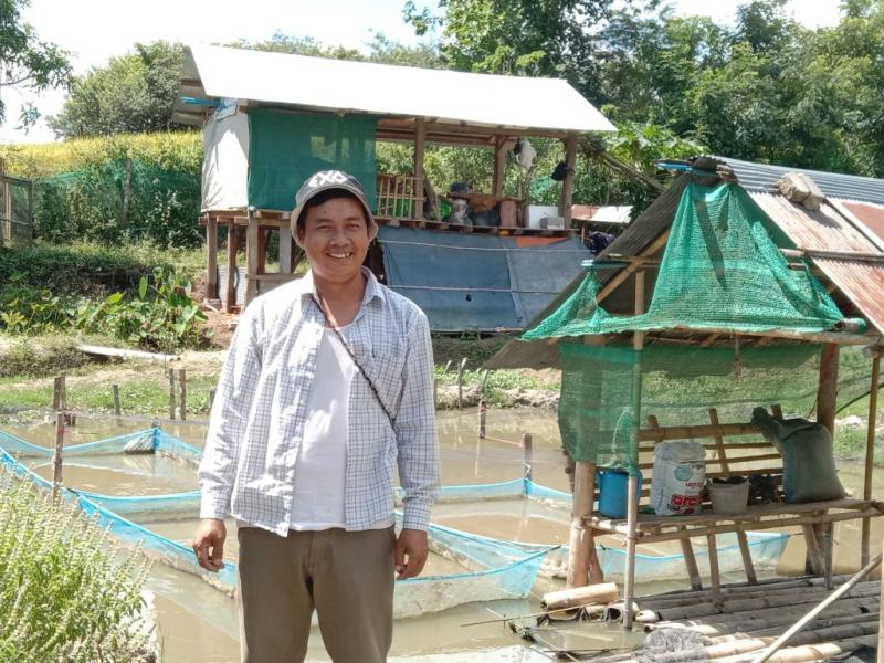 Aung Kyaw Lat shows his nutrition-sensitive aquaculture pond in Kengtung Township, Myanmar. Nutrition sensitive-approaches are proving to be a solution for improved health in a country where only four out of ten households have access to nutritious diets. Photo supplied by Kyaw Lat.