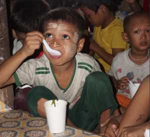 A child eating porridge with dried small fish powder mixture. Photo by Quennie Rizaldo, WorldFish.