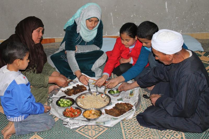  Abdallah family eating fish for lunch at Abbassa, Sharkia, Egypt. Photo by Mona El Azzazy, 2015.