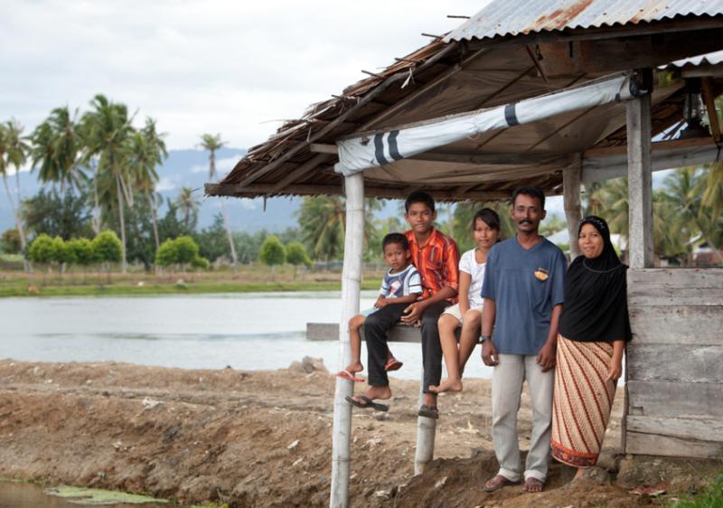 Shrimp farmer Rusli and his family, Aceh, Indonesia. Photo by Mike Lusmore.