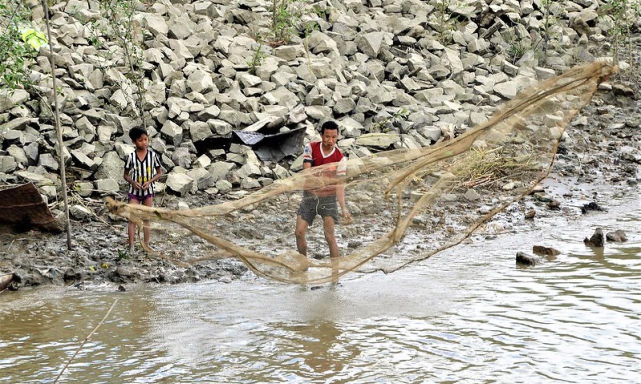 Fisherman and son fishing in the Twante Canal, Myanmar. Photo by Michael Akester.