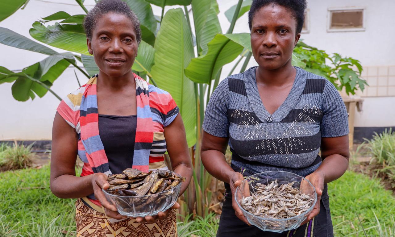 Fish farmers Agnes and Acinta pose with dried fish from their ponds in Luwingu, Zambia. Photo by Doina Huso.