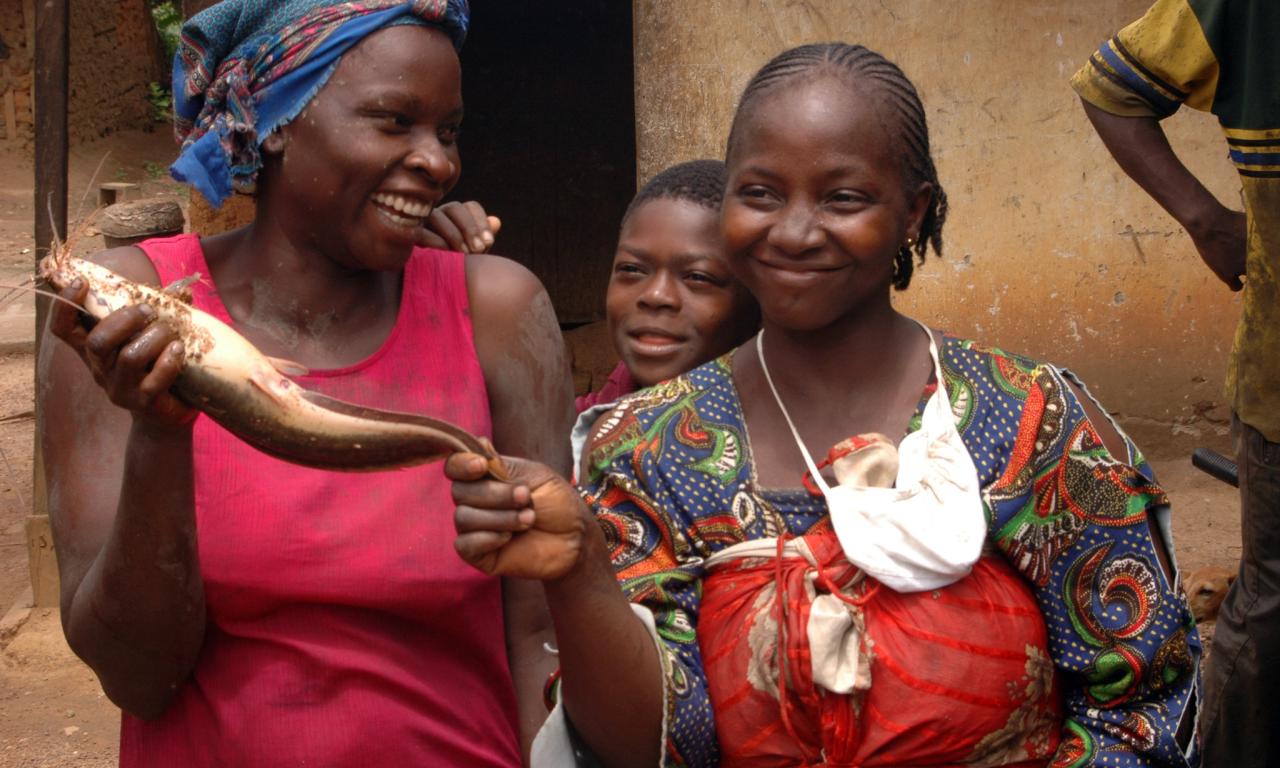 Fisherwomen hold a catfish harvested from their pond in Cameroon. Photo by Randall Brummett.