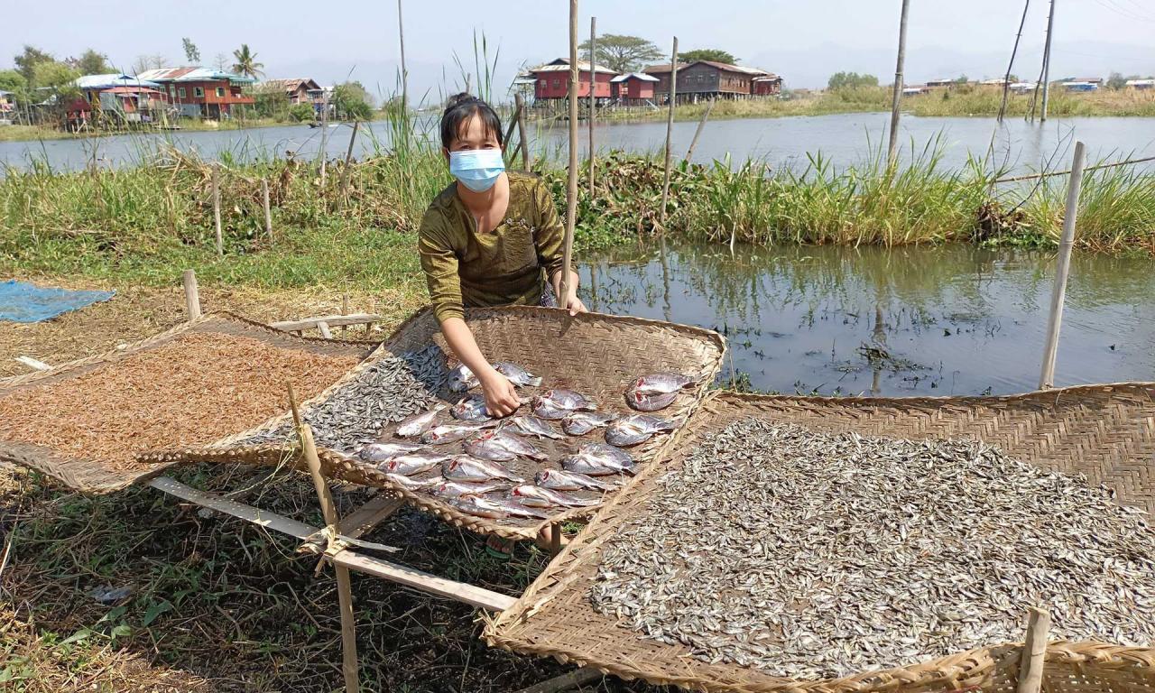 Burmese fish trader Daw Lae Lae Soe poses with her dried fish. Photo by Kyaw Moe Oo.