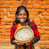 A girl showing nutrient-rich small fish mola (Amblypharyngodon mola), Amtoli, Barguna, Bangladesh. Photo by Md Masudur Rahaman, WorldFish.